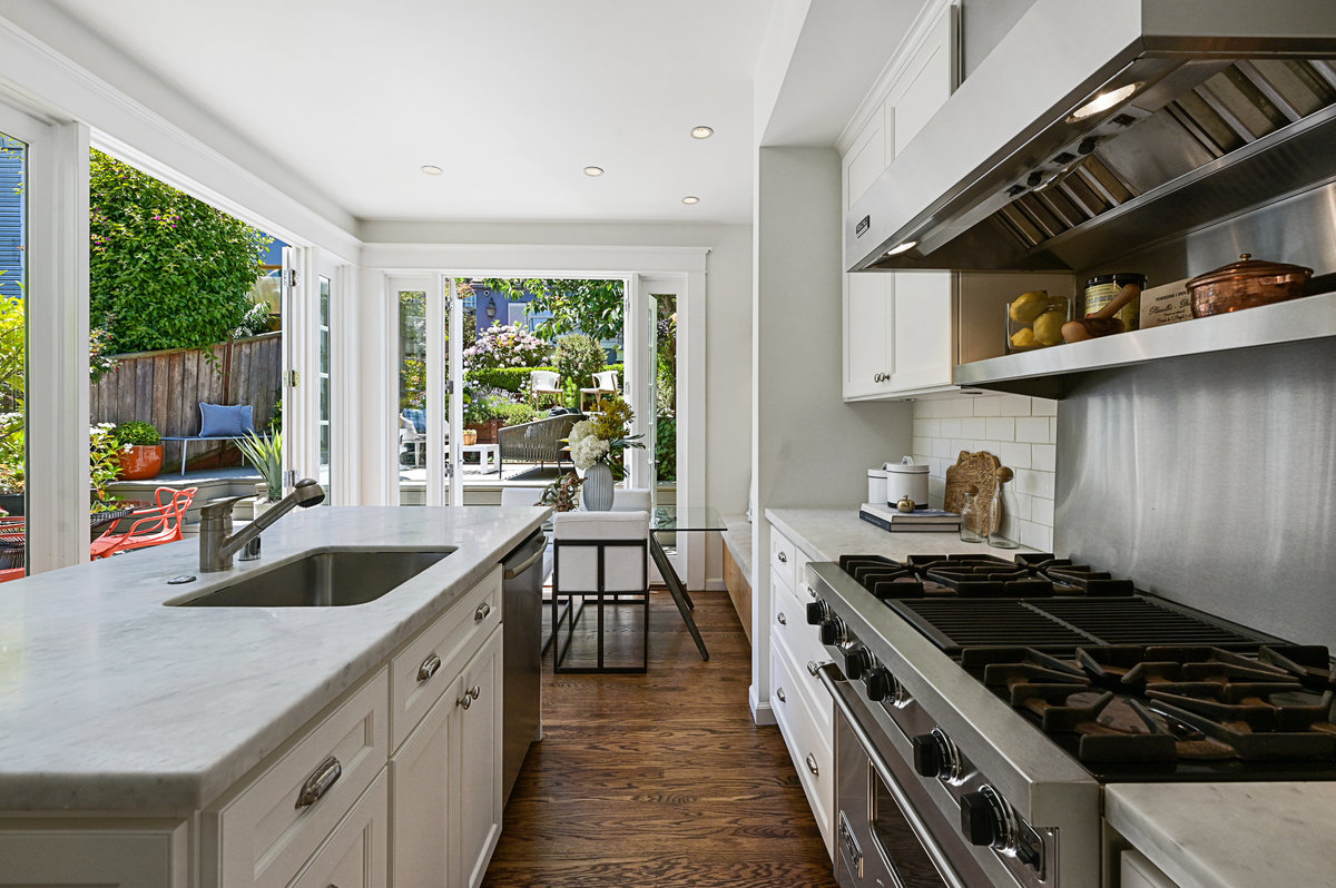 Gourmet kitchen with dining area and French doors to deck + terraces