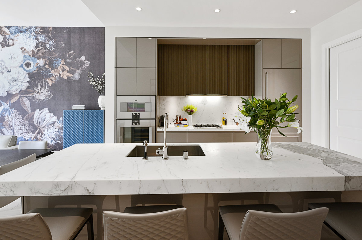A stunning European kitchen with center island counter seating and Carrara marble counters.
