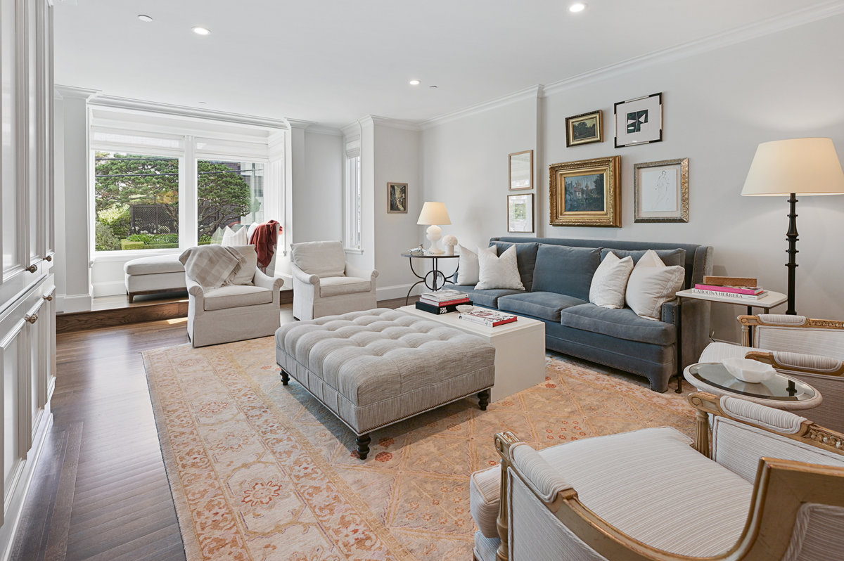 the living room enjoys a wall of beautiful floor-to-ceiling cabinets.