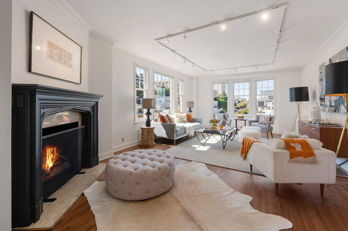 Elegant southwest corner living room with fireplace