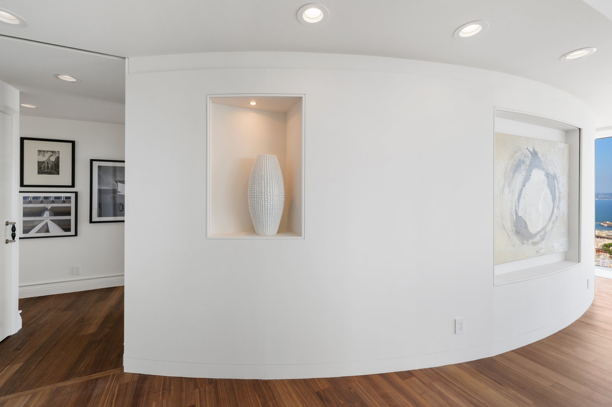 Curved wall between great room and private hall leading to bedroom suites