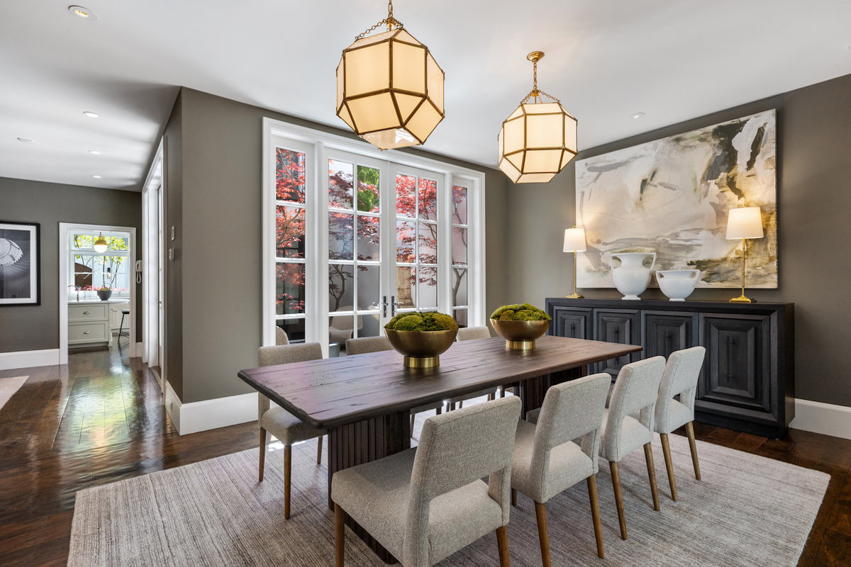Perfect for entertaining, the dining room leads to the bar and butler's pantry, with kitchen in background