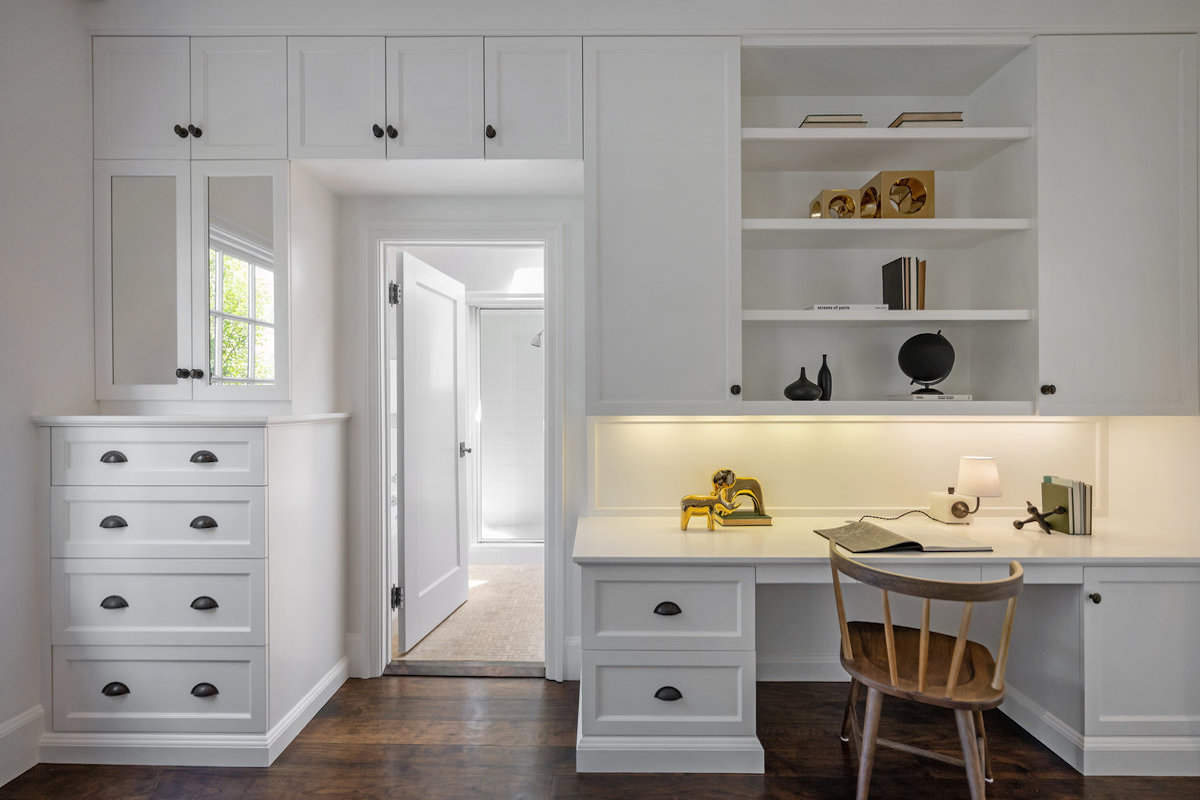 Cabinetry & desk area of front bedroom suite; bath's shower stall seen through doorway