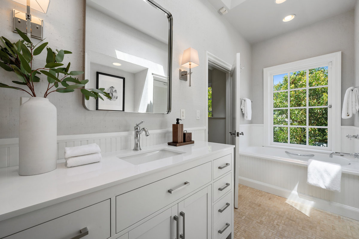 Ensuite bath to third/front bedroom with tub at window, separate water closet