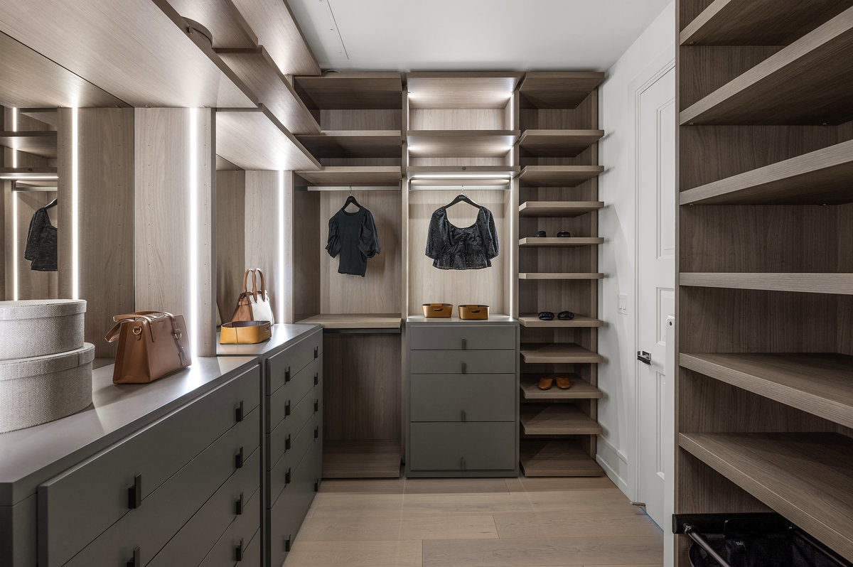 Image 2 of 2 of the primary suite's large custom closet with enhanced lighting