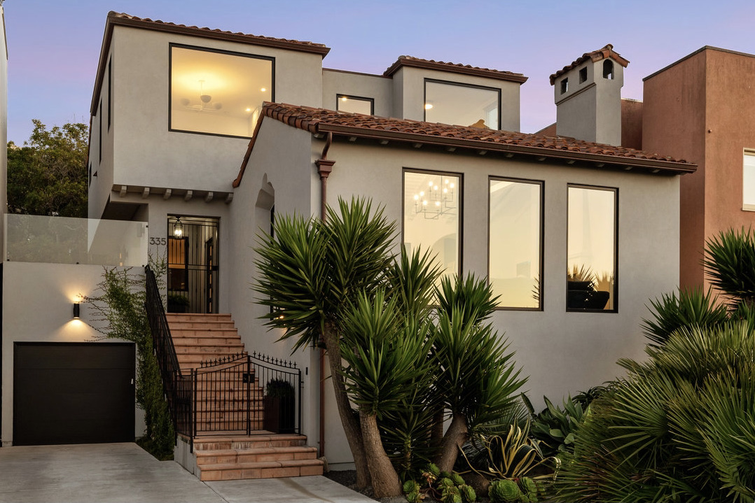 Front facade at twilight; lush drought-resistant landscaping