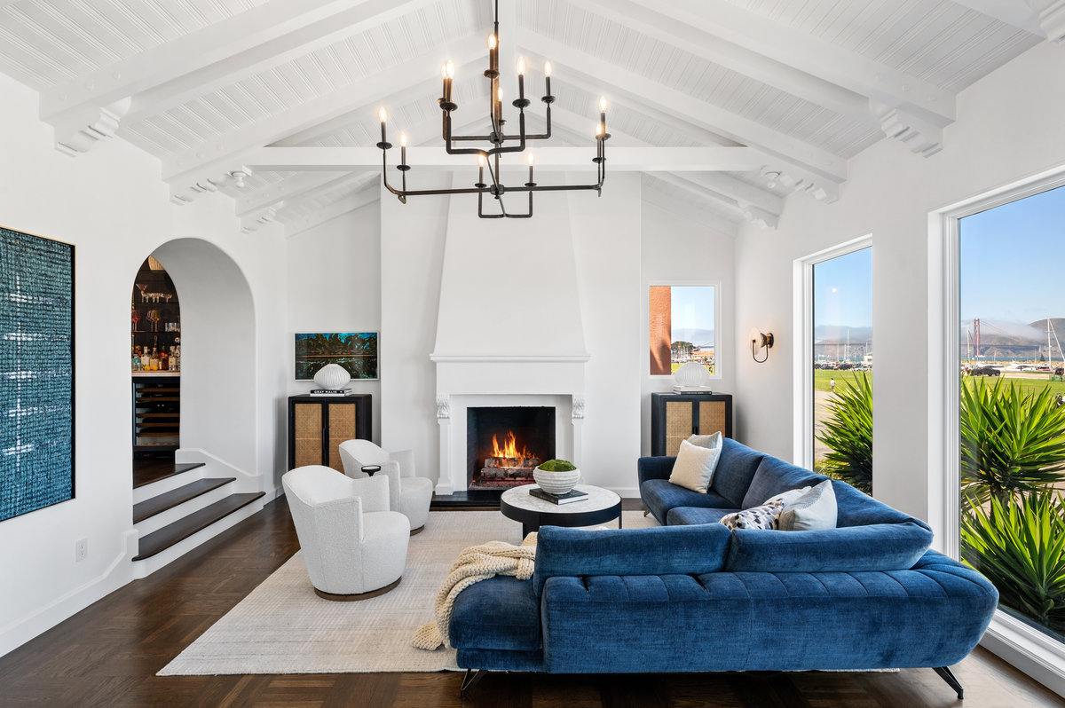 Living room with gas fireplace, open beam ceiling