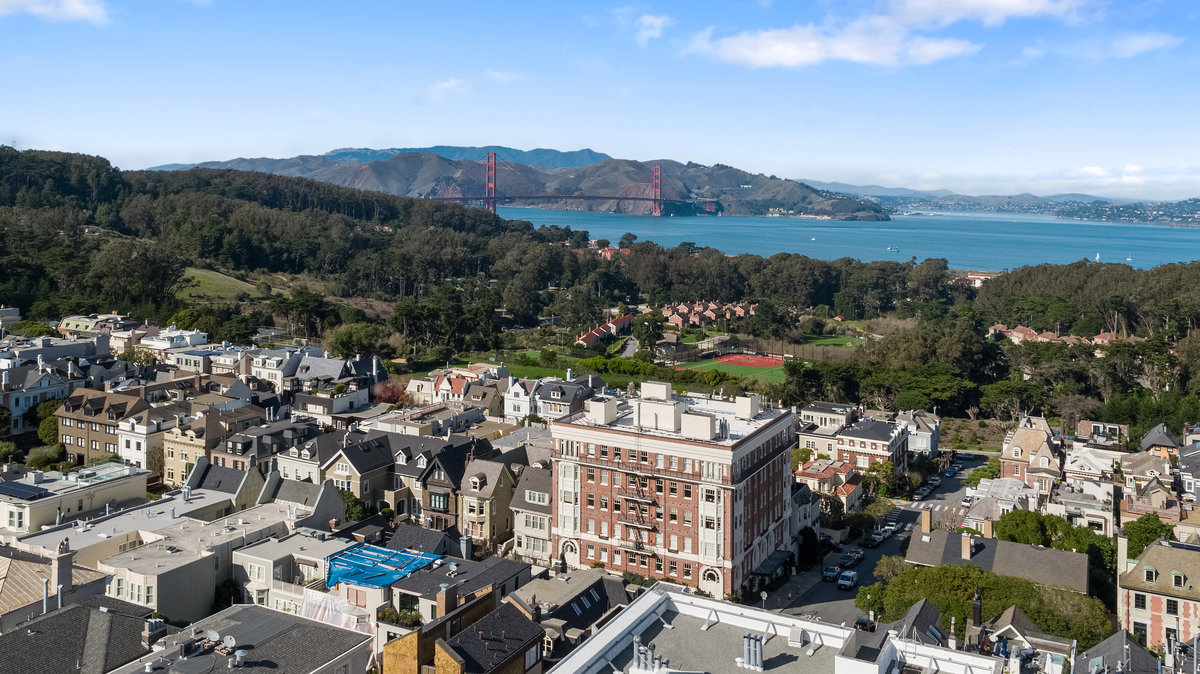 Aerial view to north; shows proximity to Presidio Wall Playground & Presidio National Park with Bay & Golden Gate Bridge in distance