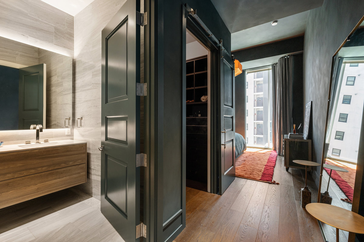 Bedroom suite with door to full bath, then door to closet before sleeping area