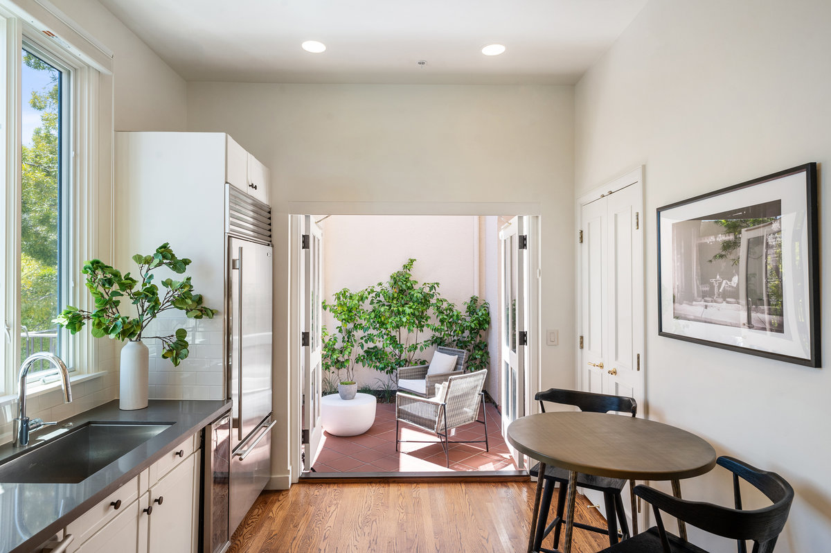 Kitchen with intimate seating opens to a large private landscaped patio