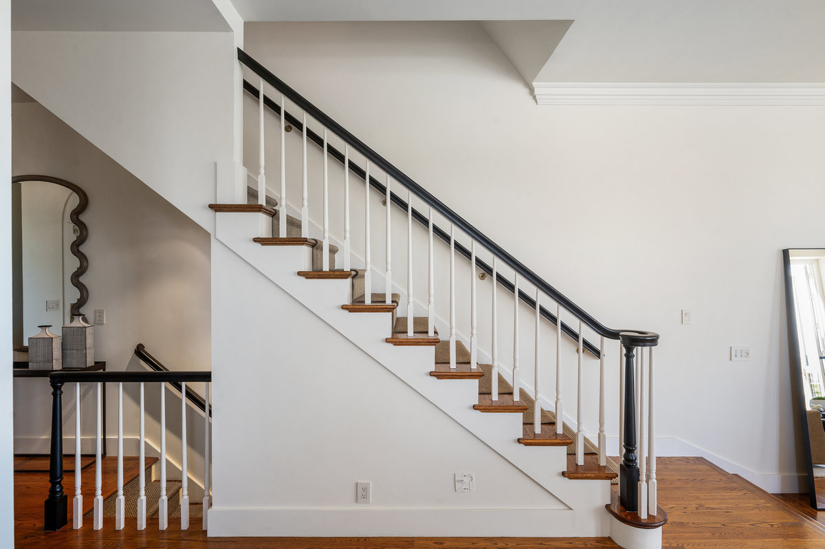 Graceful staircase leads to the residence’s upper level