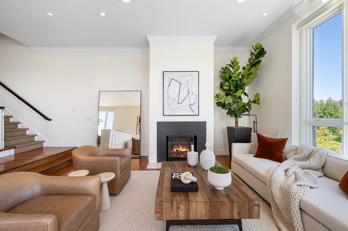 The living room enjoys 11’ ceilings and gas fireplace with charcoal quartz surround