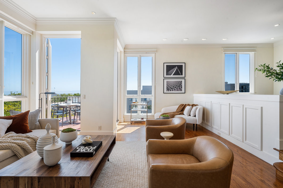 The elegant sunken living room enjoys floor-to-ceiling east windows