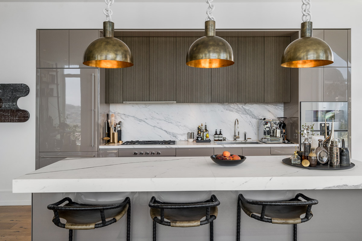 European kitchen with counter seating, statuario marble, Arclinea cabinetry and Gaggenau appliances