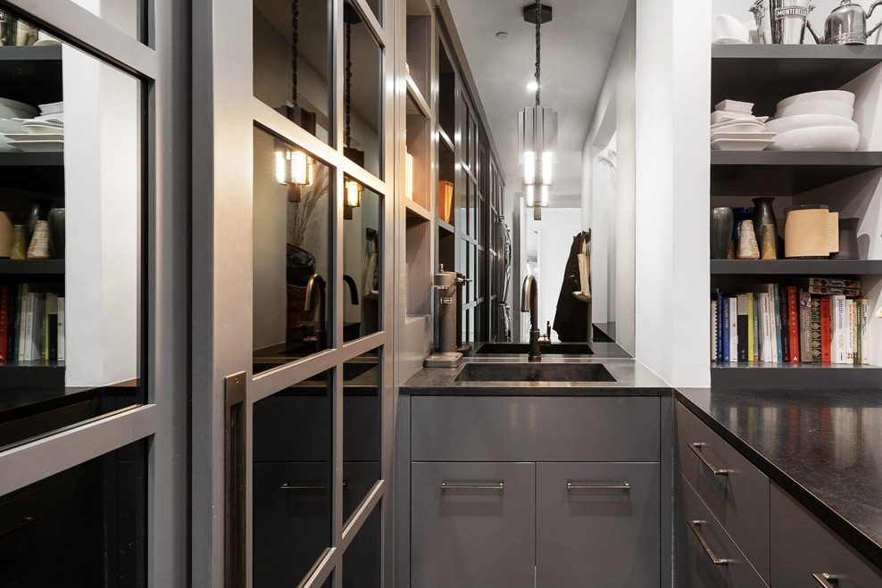 Sink and alcove area of the laundry/pantry; wall of storage on the left