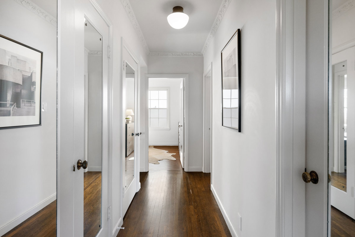 Upper level hall leading to other rooms and interior staircase to roof