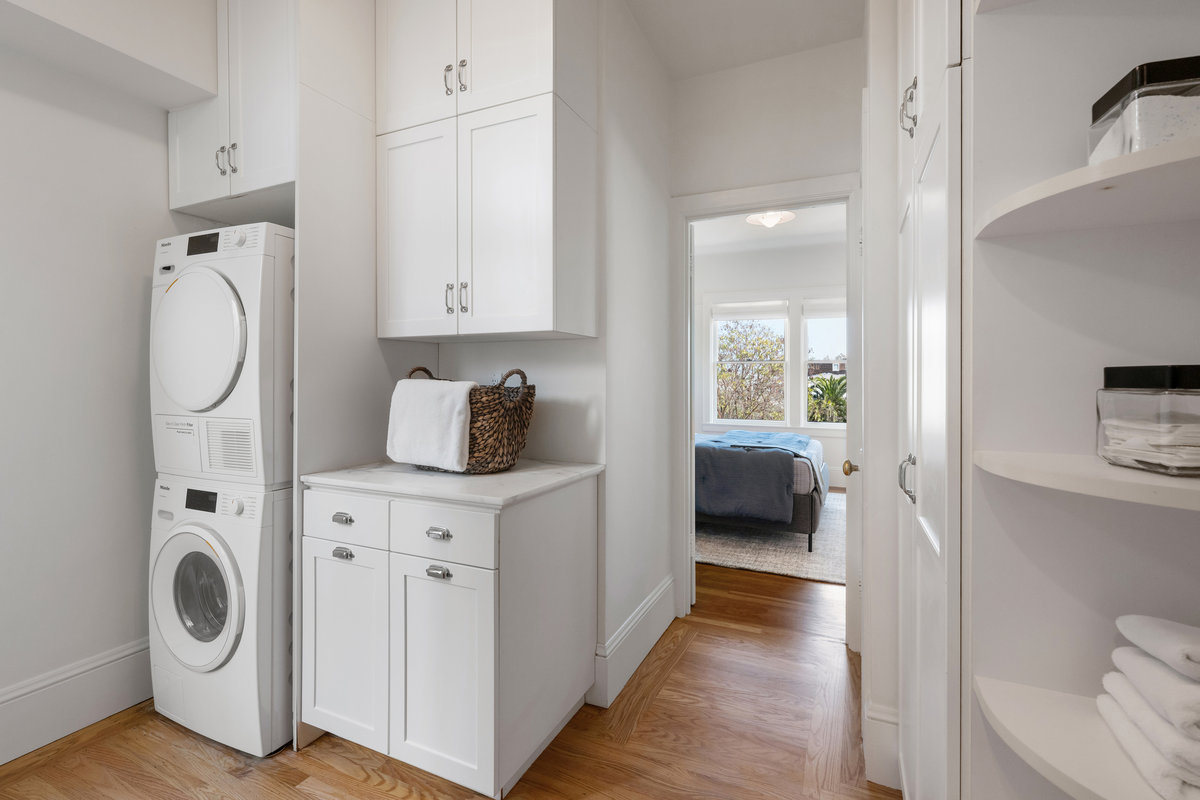 Laundry/pantry with plenty of storage; bedroom two entrance in background