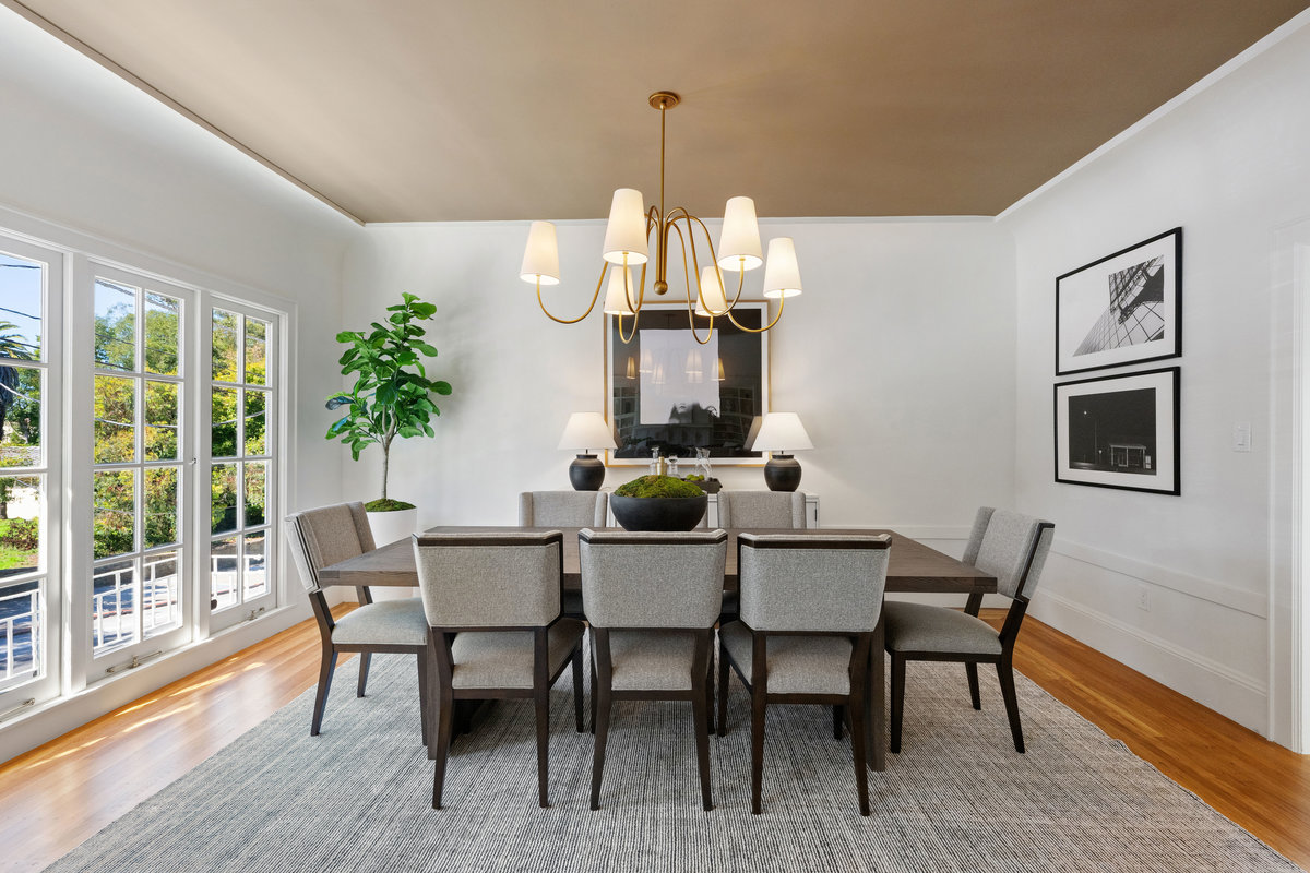 Dining room with ceiling detail, wall of west windows with its own decorative balcony