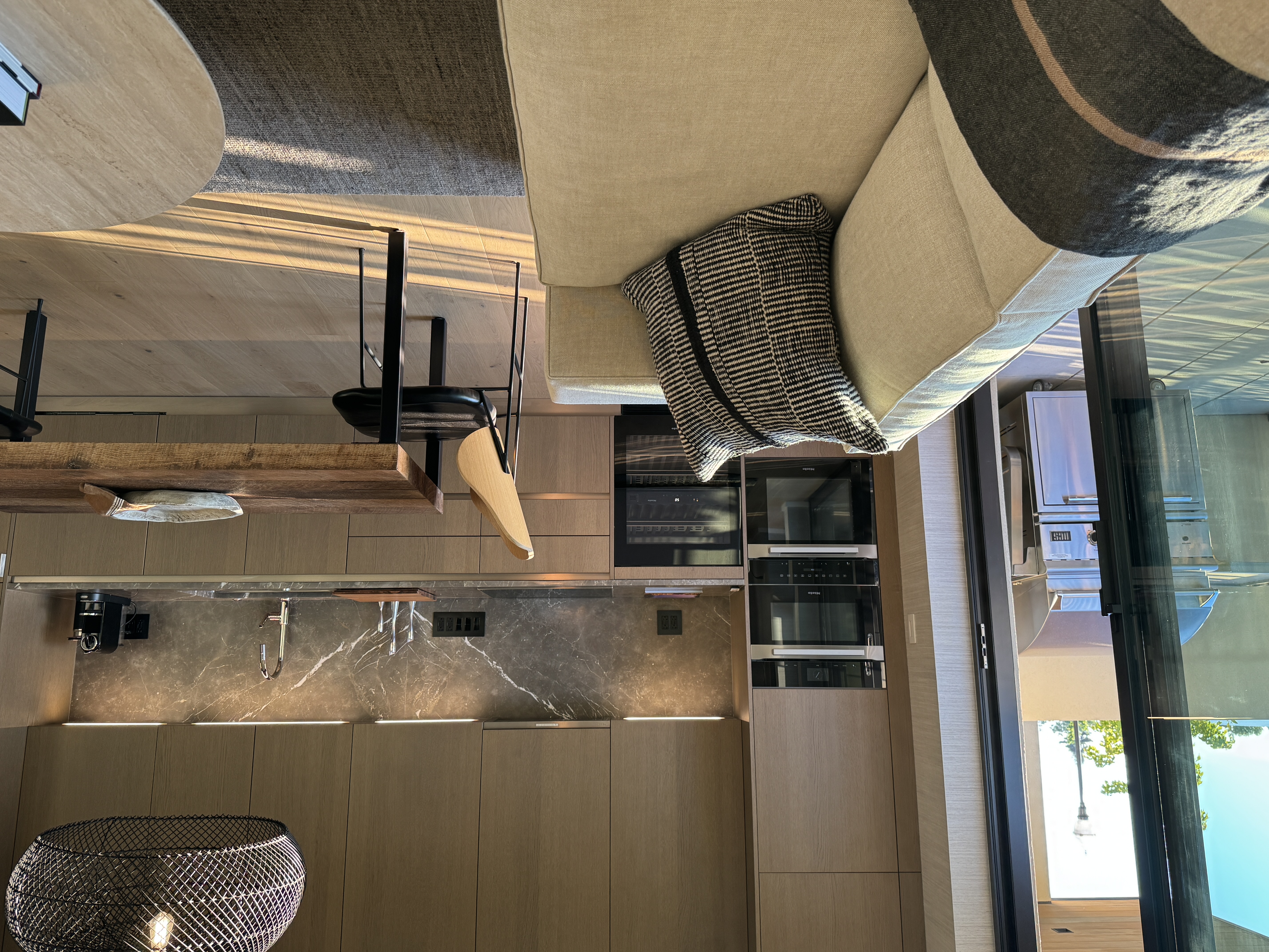 Great room with Miele kitchen opens to patio with seating and gas grill