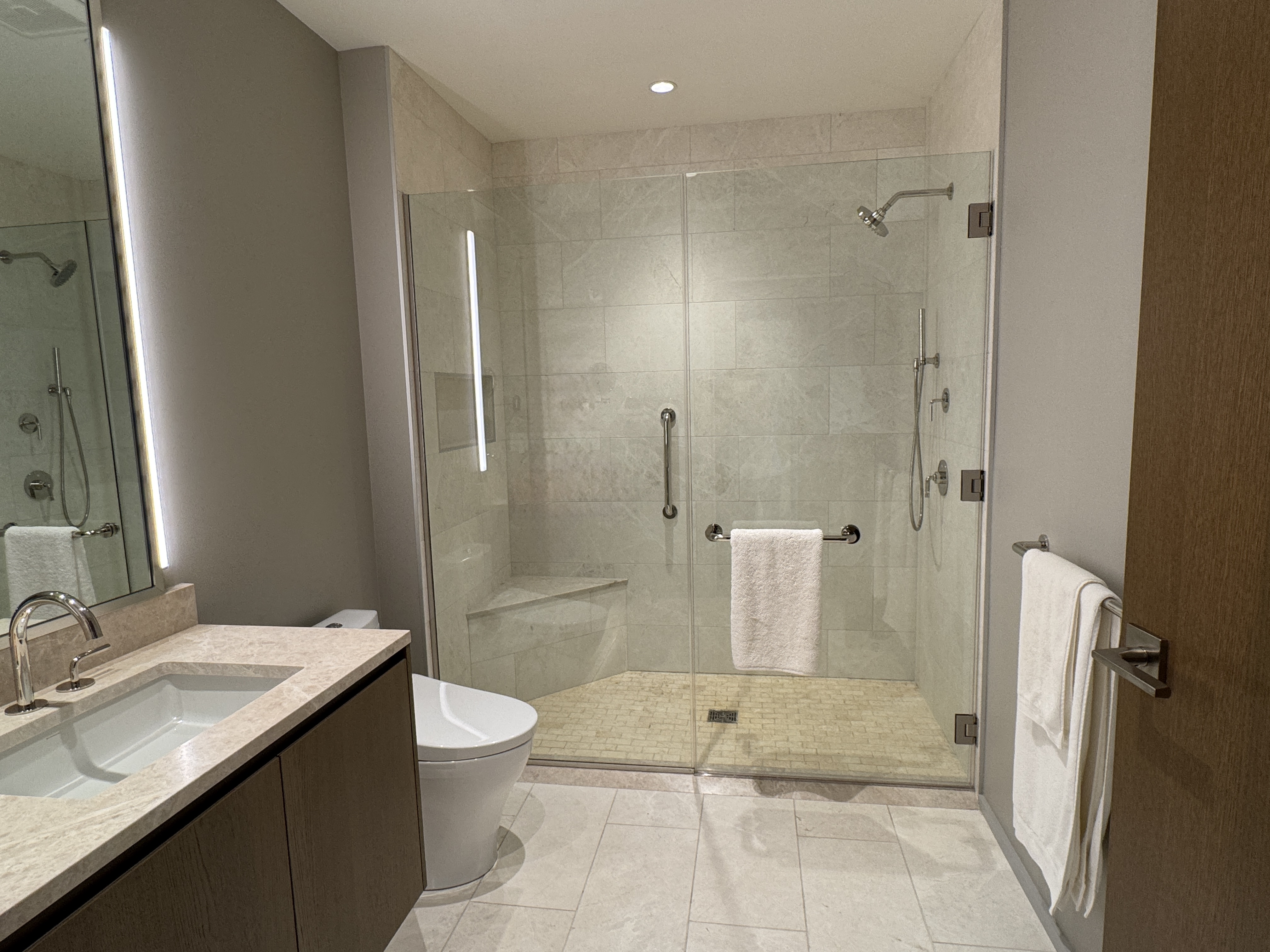 Large shower with marble seat
