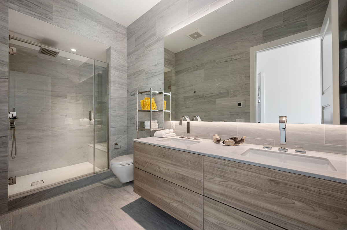 Primary bath with dual sinks and shower, marble clad