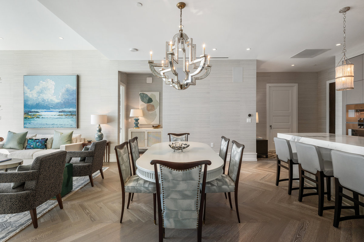 Residence 502's great room with chevron pattern wood floors and pale grasscloth wall covering