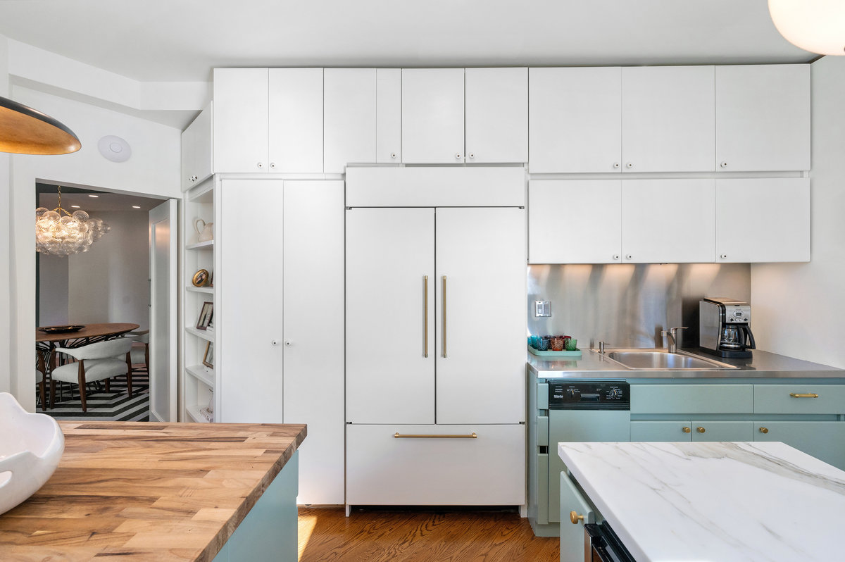 Kitchen, with second sink, leads to dining room via doorway on the left