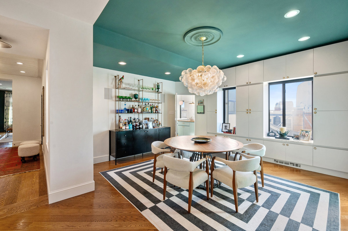 Dining room with beautiful chandelier, built-in cabinetry, west windows