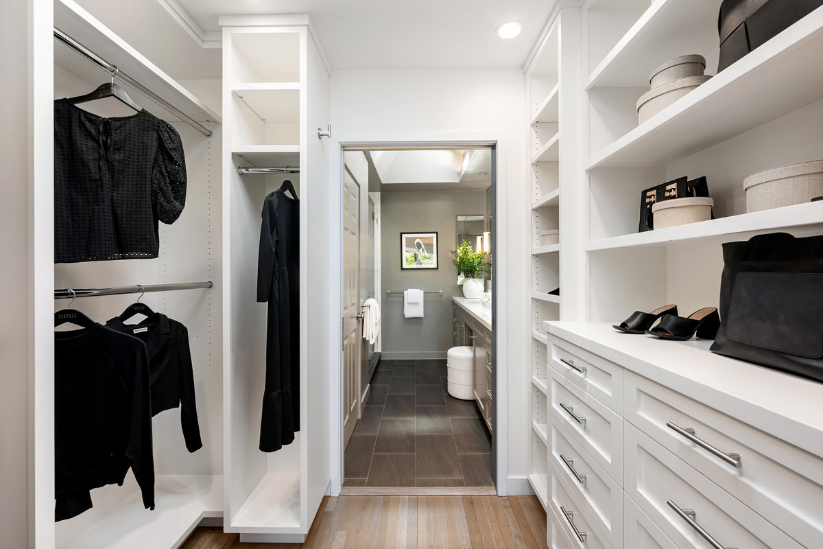 Generous primary closet leads to ensuite bath