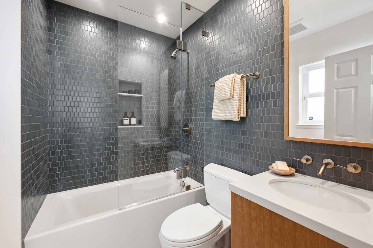 Beautifully tiled third full bath with shower over tub, ensuite to third bedroom