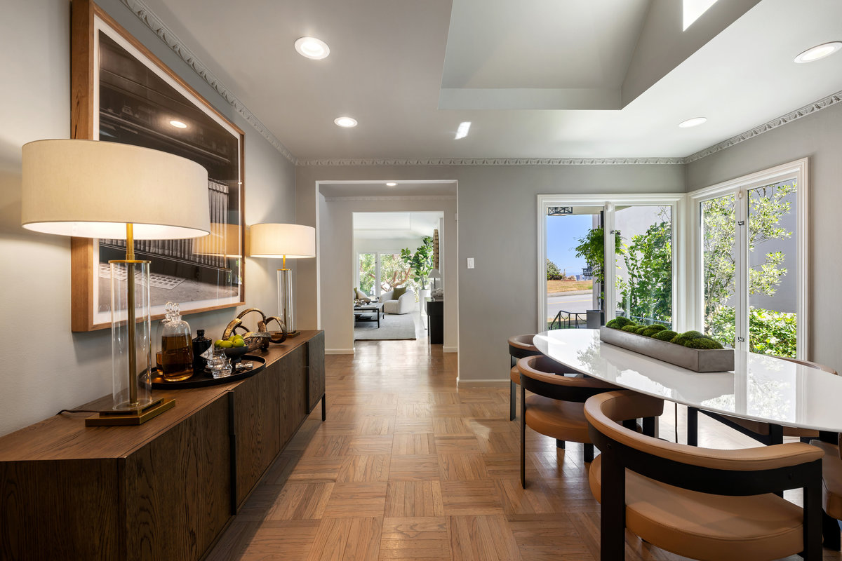 Dining room with large windows, skylight and original crown moulding
