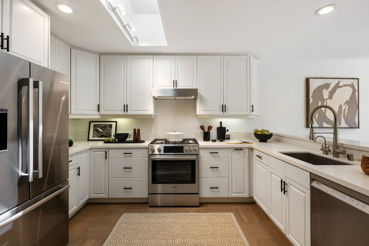 Gas kitchen with new Bosch appliances, white quartz counters, skylight