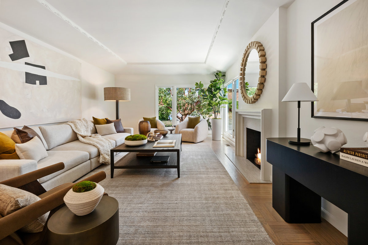 Generously scaled living room with fireplace and corner windows