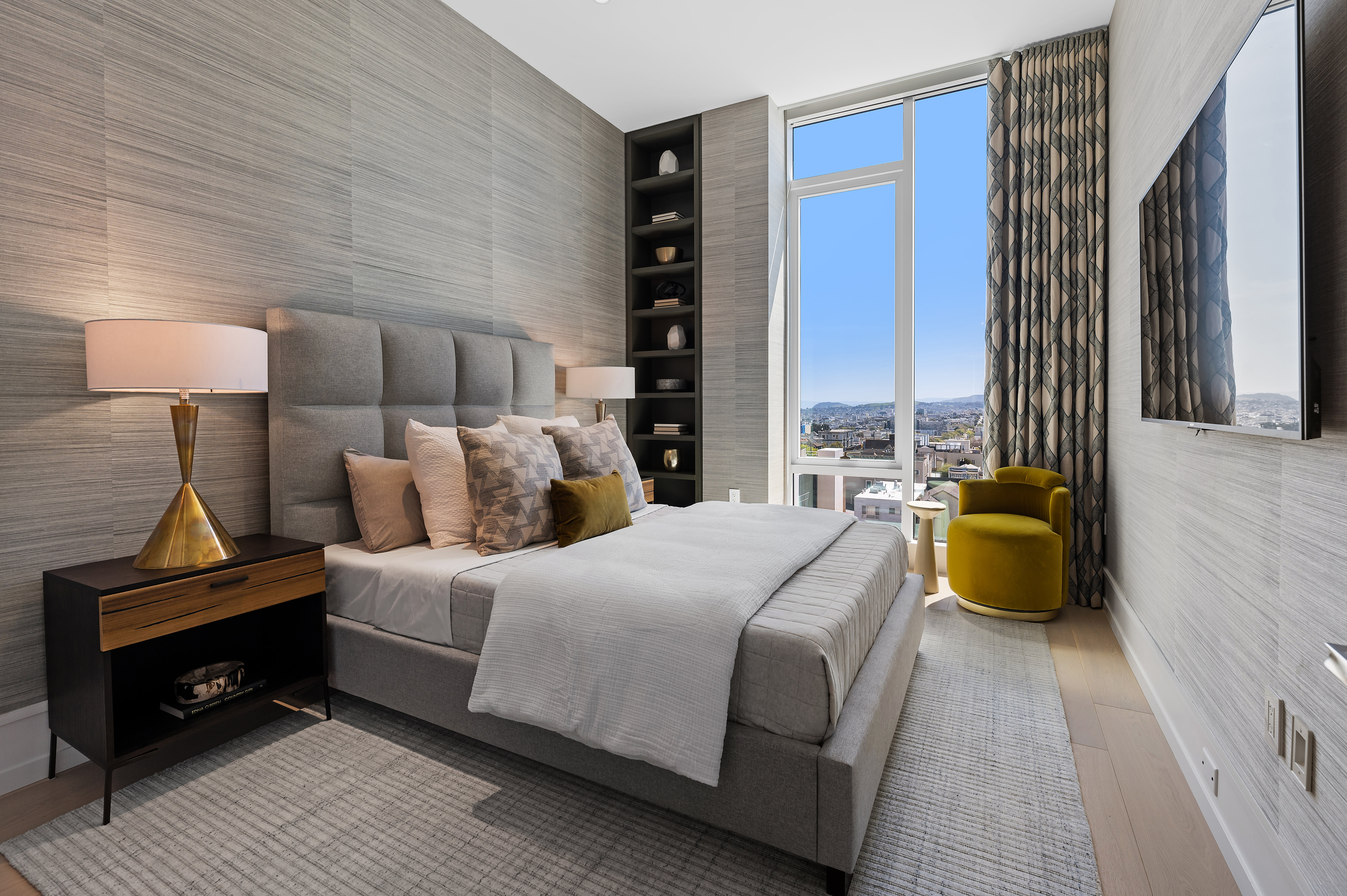 Guest bedroom with custom bookcases, flat screen TV. Could alternatively serve as a home office. NOTE: wallpaper & drapes removed by owner
