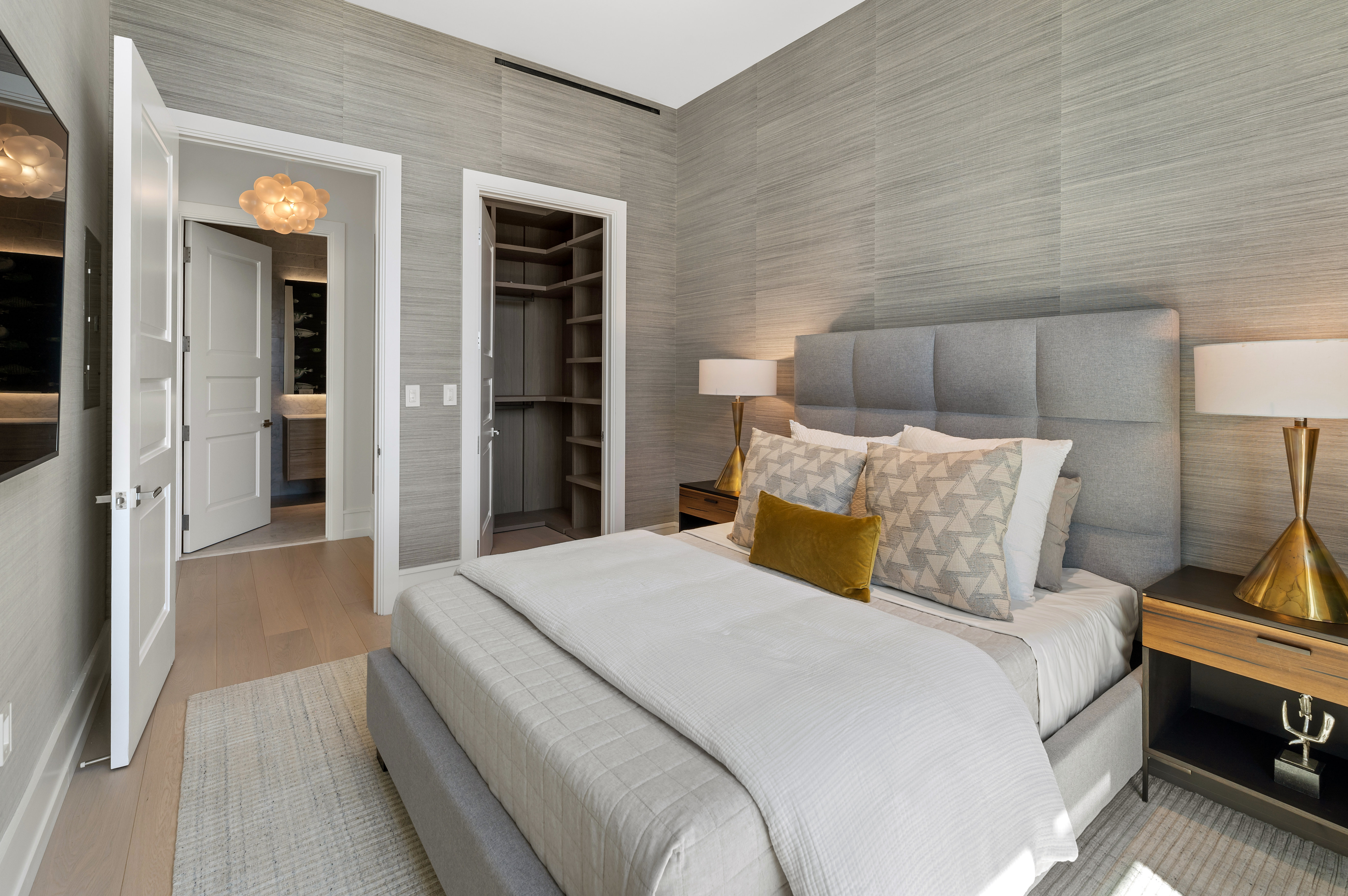 Guest bedroom with custom closet; doorway to guest bath. NOTE: wallpaper no longer exists.