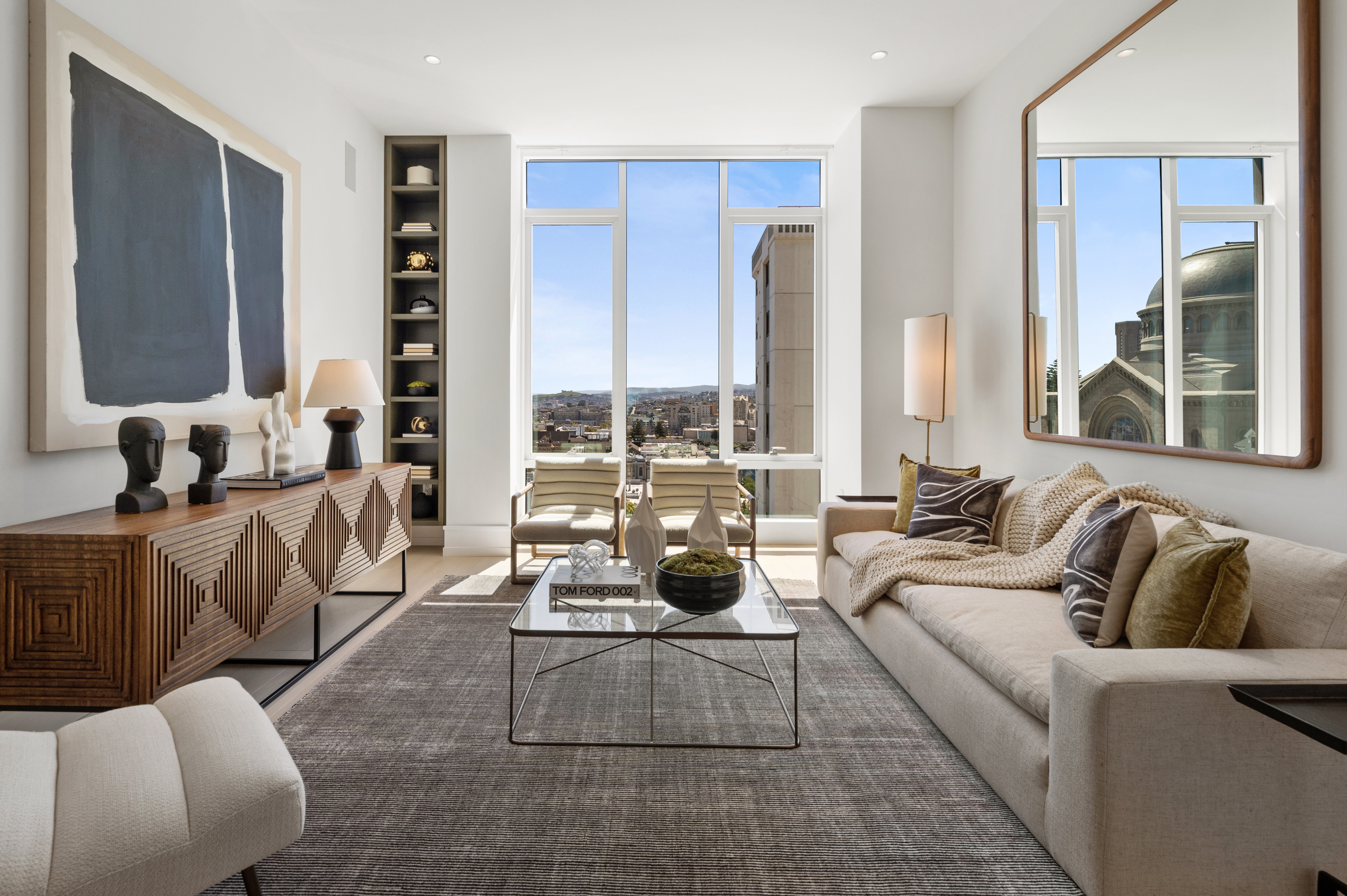 Living area of #503's great room. Views far across the City to the southern hills. Note the synagogue reflected in the mirror.
